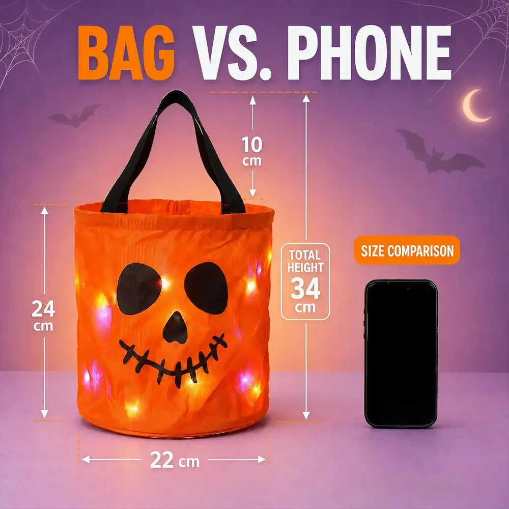 An orange pumpkin-shaped Halloween bucket bag with black handles and a jack-o'-lantern face, shown with size measurements and a phone for a size comparison on a purple Halloween-themed background.