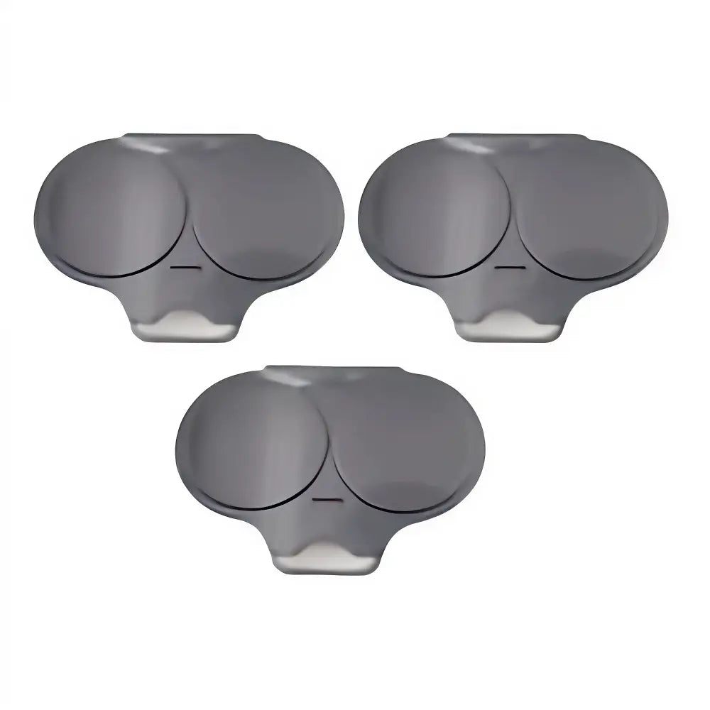 Three dark gray plastic replacement caps with circular inserts, arranged on a plain white background.