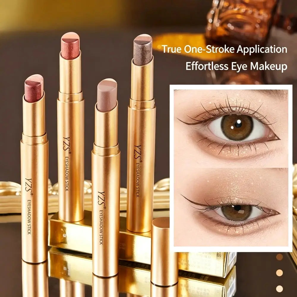 Four gold YZS Eyeshadow Stick tubes displayed upright on a reflective surface, with an inset showing close-up eye makeup results. Text reads 'True One-Stroke Application Effortless Eye Makeup.