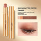 A gold cosmetic stick and its cap shown on a beige background, with text reading '03#FINE GLITTER COFFEE ORANGE' and a small eye makeup swatch. The product appears to be a shimmer eyeshadow stick or lip/eye color in a warm coppery orange shade.