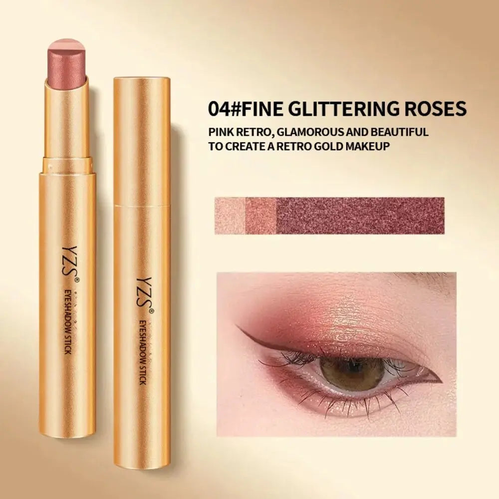 Gold eyeshadow stick and cap shown on a beige background with text reading '04#FINE GLITTERING ROSES' and a small eye makeup close-up demonstrating the pink glitter shade.