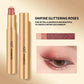 Gold eyeshadow stick and cap shown on a beige background with text reading '04#FINE GLITTERING ROSES' and a small eye makeup close-up demonstrating the pink glitter shade.