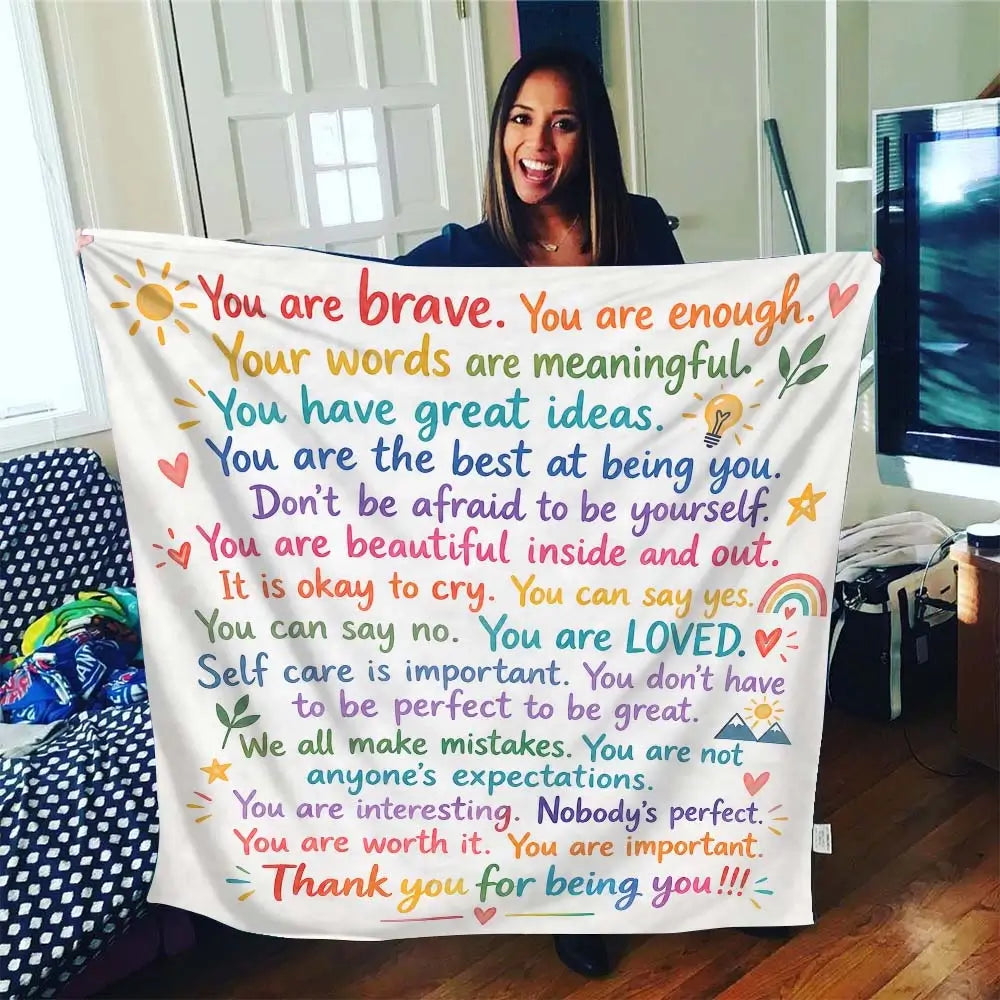 Affirmation blanket styled as a cozy throw on a sofa