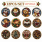 A set of 12 round diamond painting ornaments featuring various Christmas-themed designs, including an owl, cat, dog, bear, angel, elf, cake, mug, pinecone, Christmas tree, poinsettia, and acorns. 