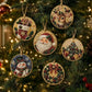 Six round beaded Christmas ornaments hang on a decorated Christmas tree. The ornaments feature festive designs including Santa Claus, a deer, a snowman, a Christmas tree, and a bow, all crafted with colorful rhinestones and gold-toned borders.