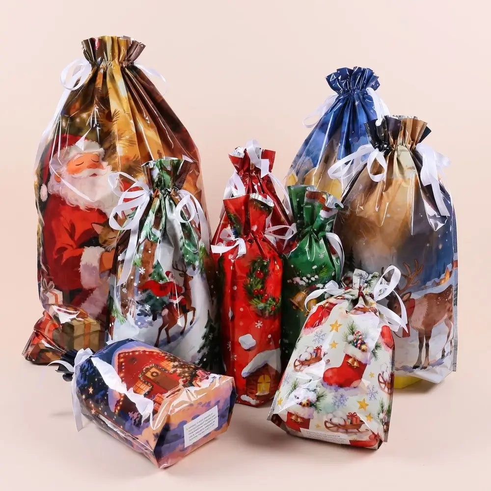 A set of Christmas-themed clear plastic drawstring gift bags with white ribbons, featuring festive holiday illustrations including Santa Claus, reindeer, snowflakes, and stockings, arranged on a solid light beige background.