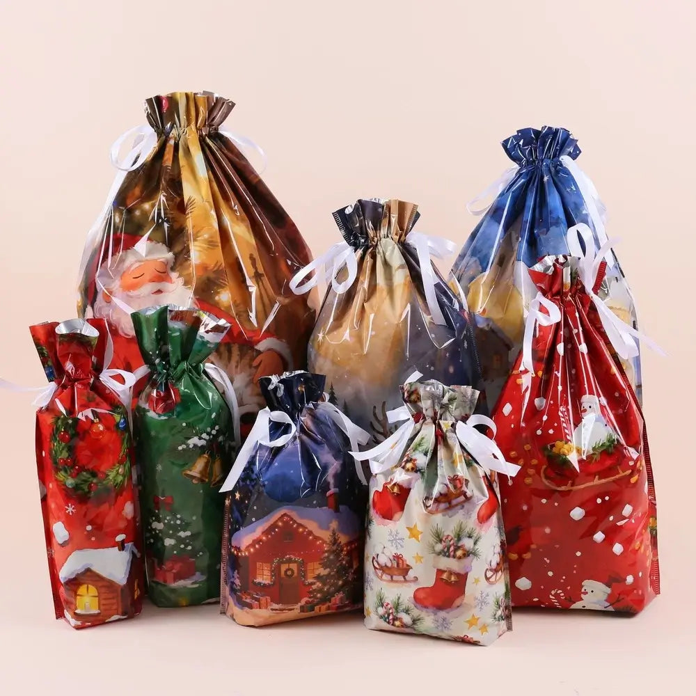 A set of Christmas-themed clear plastic drawstring gift bags with white ribbons, shown in multiple festive colors and patterns including Santa, snowflakes, holiday houses, and wreaths, arranged on a solid light beige background.