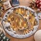 A round area rug featuring a detailed Christmas-themed grand staircase interior with snow, warm lights, and decorated trees, styled on a wooden floor with holiday pillows, books, a teddy bear, and a mug.