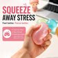 A hand holding a translucent pink glittery stress ball against a blurred desk background with promotional text reading 'SQUEEZE AWAY STRESS' and a pink benefit badge.