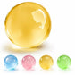 A large translucent yellow glass marble ball is shown above four smaller translucent glass marbles in blue, pink, yellow, and green, all on a white background.