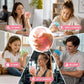 A collage showing a person holding and squeezing a translucent pink stress ball in five lifestyle scenes: at work, while studying, at home, relaxing, and after workout. A central close-up shows hands squeezing the pink ball.