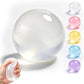 Clear gel ball with a hand holding it, surrounded by other colored gel balls on a white background