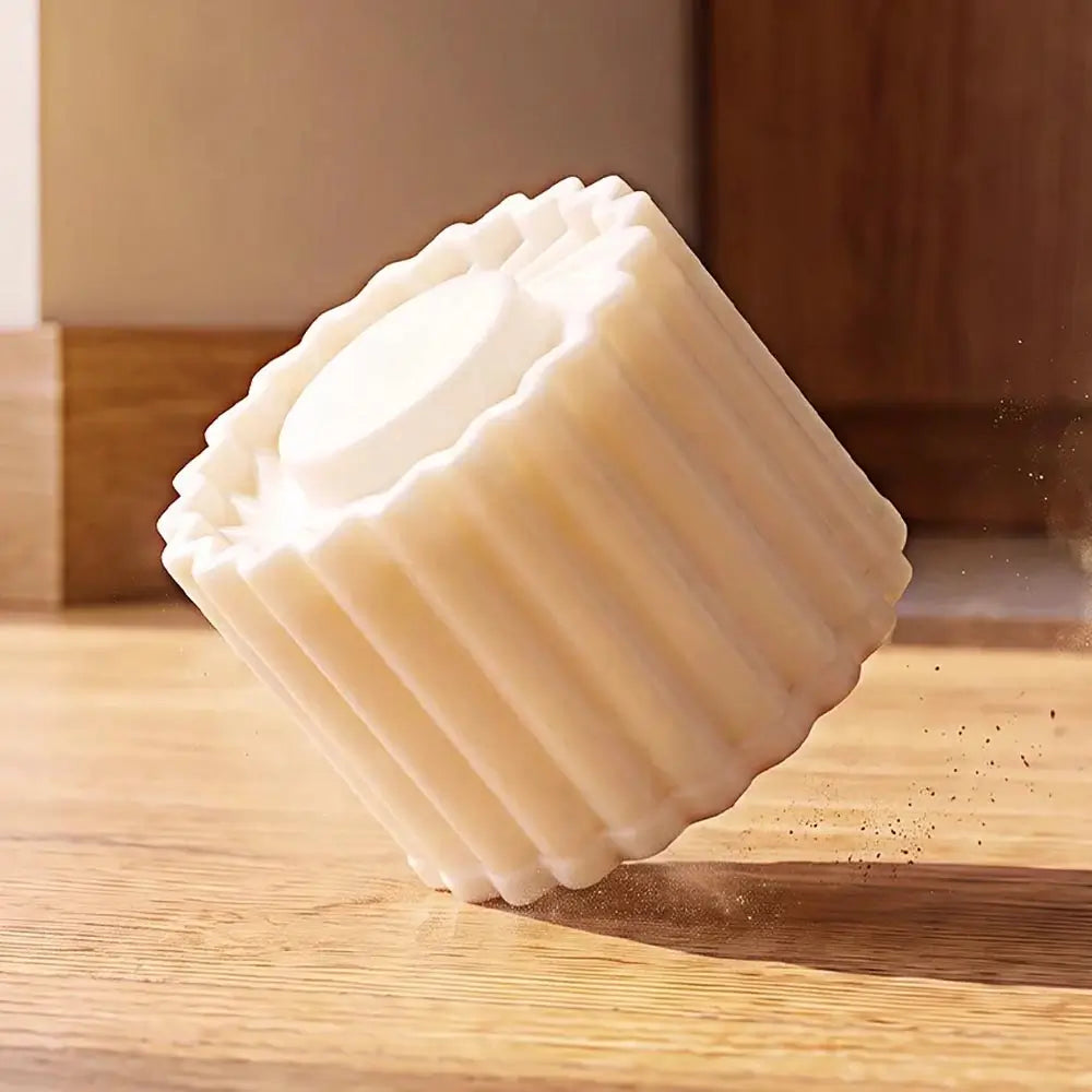 A double-ended pastry mold standing on a wooden surface in warm indoor lighting.
