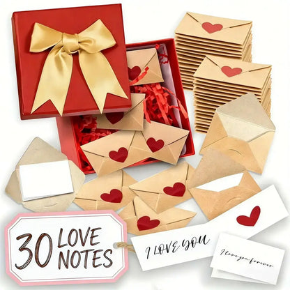 A Valentine's Day gift set featuring a red box with a gold ribbon, kraft paper envelopes with red hearts, white cards, and a hanging tag that reads '30 LOVE NOTES'.