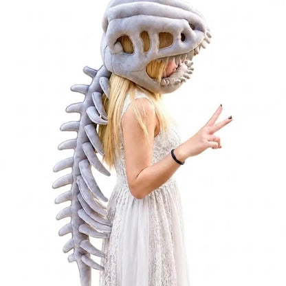 A woman wearing a plush dinosaur skull and spine costume, posed in profile against a plain white background.