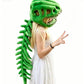 A woman wearing a green dinosaur plush monster costume with a large green dinosaur head and long spiky tail, posed against a plain white background.