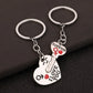 Two keychain pairs with heart and key designs on a dark background