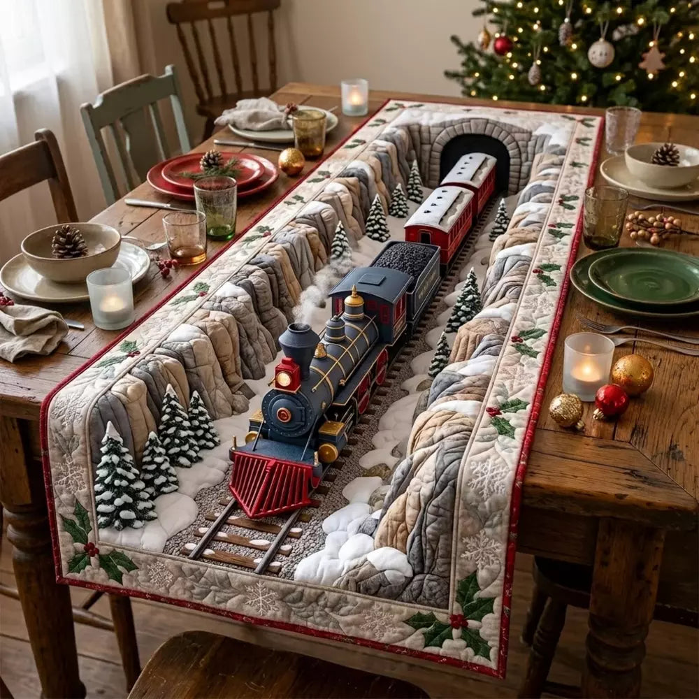 A quilted table runner with snowy mountain tunnel track and a vintage steam train beside mini Christmas trees on a wooden table with candles and ornaments