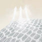 A close-up of a white honeycomb-patterned dome or enclosure with three translucent arrows rising upward from the top against a pale beige background.