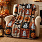 Close-up of pumpkin and ghost motifs on a plaid Halloween blanket