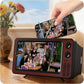 Small TV set displaying a scene from a sitcom, held by a hand with a vase of flowers in the background.