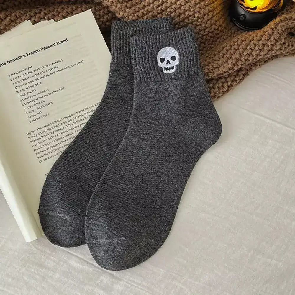 Halloween crew socks featuring an embroidered skull motif