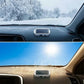 A car dashboard-mounted solar phone charger shown in two environments: a snowy winter road scene on the top half and a bright sunny blue sky on the bottom half.