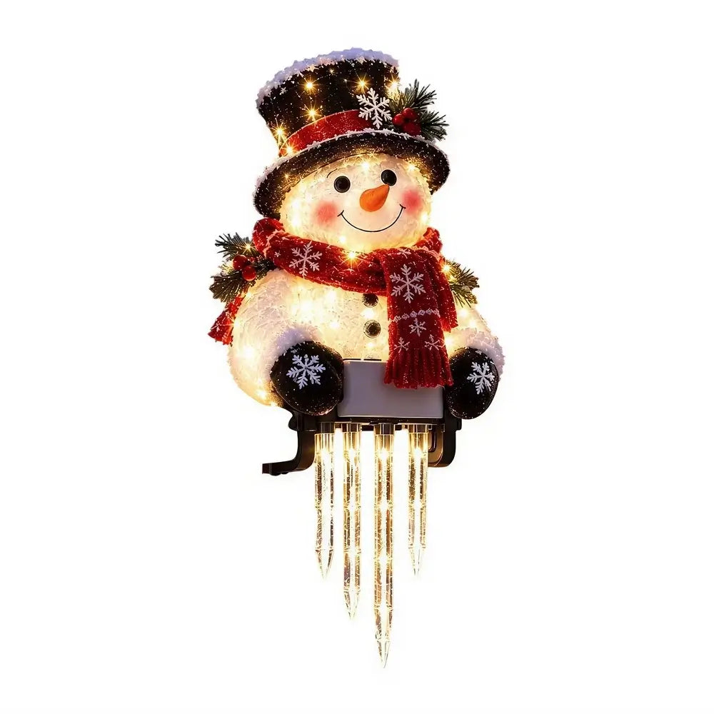 A festive snowman light decoration wearing a black top hat with white snow and a red scarf, sitting in a sled with glowing icicle-like lights hanging below, shown on a plain white background.