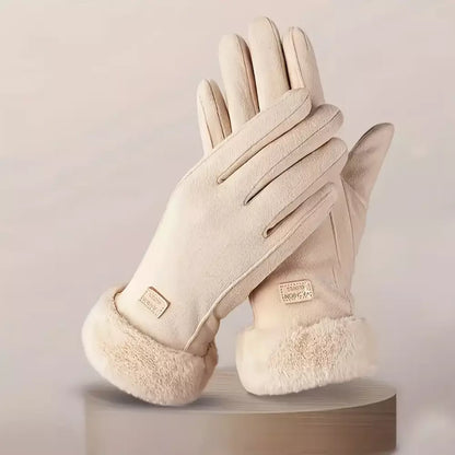 A pair of beige winter gloves with soft faux-fur trim at the cuffs, displayed on a round pedestal against a light beige background.
