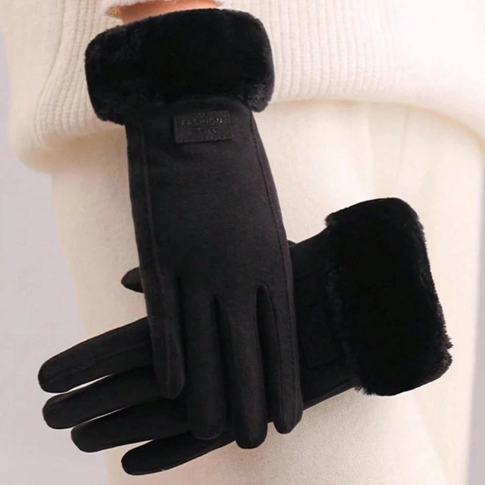 Black winter gloves with plush faux-fur cuffs, shown on a model wearing a cream-colored knit sweater. 