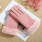 A pair of dusty pink winter gloves with plush faux-fur cuffs, arranged on a white printed card over a beige woven fabric.