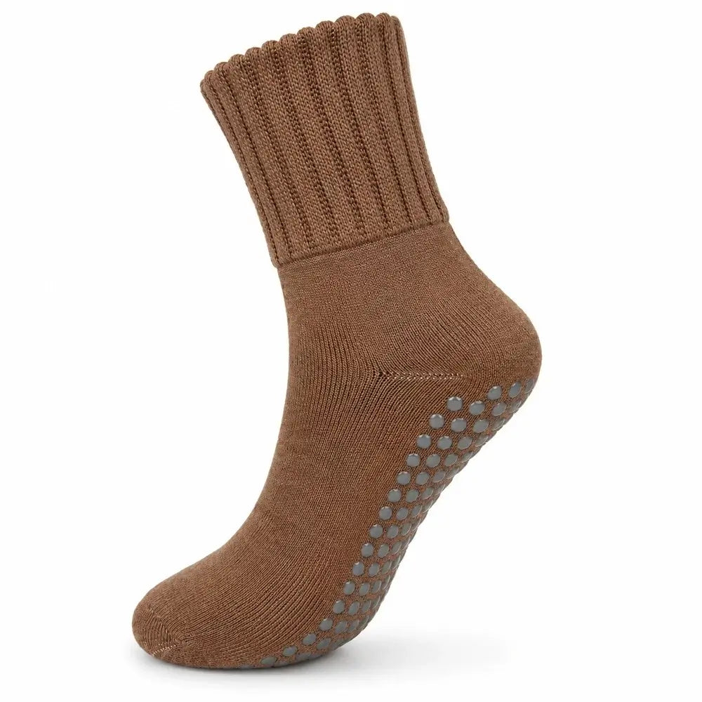 A single brown ankle sock with gray non-slip grip dots on the sole, shown against a plain white background.