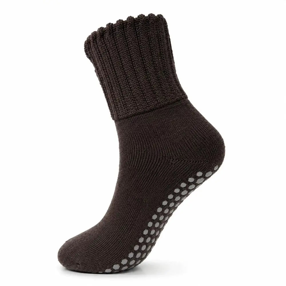 A single dark brown ribbed knit slipper sock with gray grip dots on the sole, shown against a plain white background.