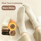 A pair of cream-colored knit socks worn on feet, shown with folded versions and a flame graphic highlighting thick Terry lining. The image includes the text 'Thick Terry Cushioning' and 'Warm Winter'.