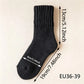 A single black ribbed knit sock shown on a light beige background with overlaid dimension arrows and text indicating measurements: 13 cm / 5.12 inch height, 19 cm / 7.